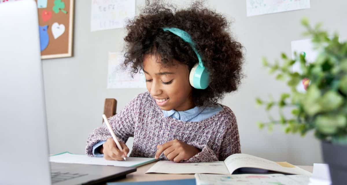 Kid with headphones doing homework