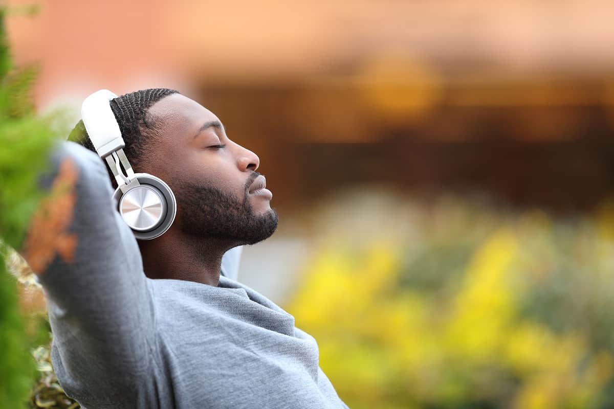 man relaxing listening to music with headphones on
